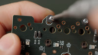 Fasten the stabilizers to the PCB using the included fasteners on the back of the PCB.